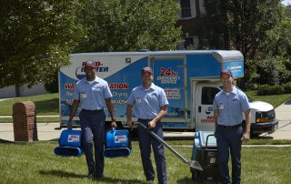 Water Restoration team smiling and walking