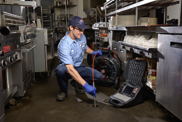 Roto-Rooter plumber doing commercial video camera inspection