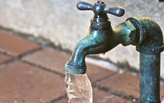 A frozen metal outdoors tap