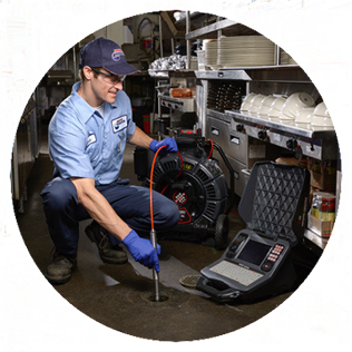 Roto-Rooter Plumber conducting video inspection