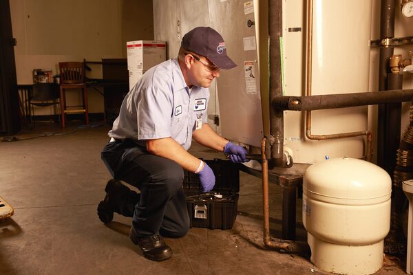 Technician installing commercial water heater