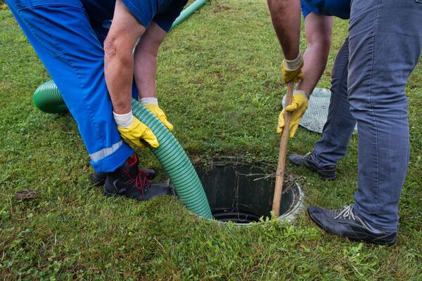 2 men cleaning septic tank